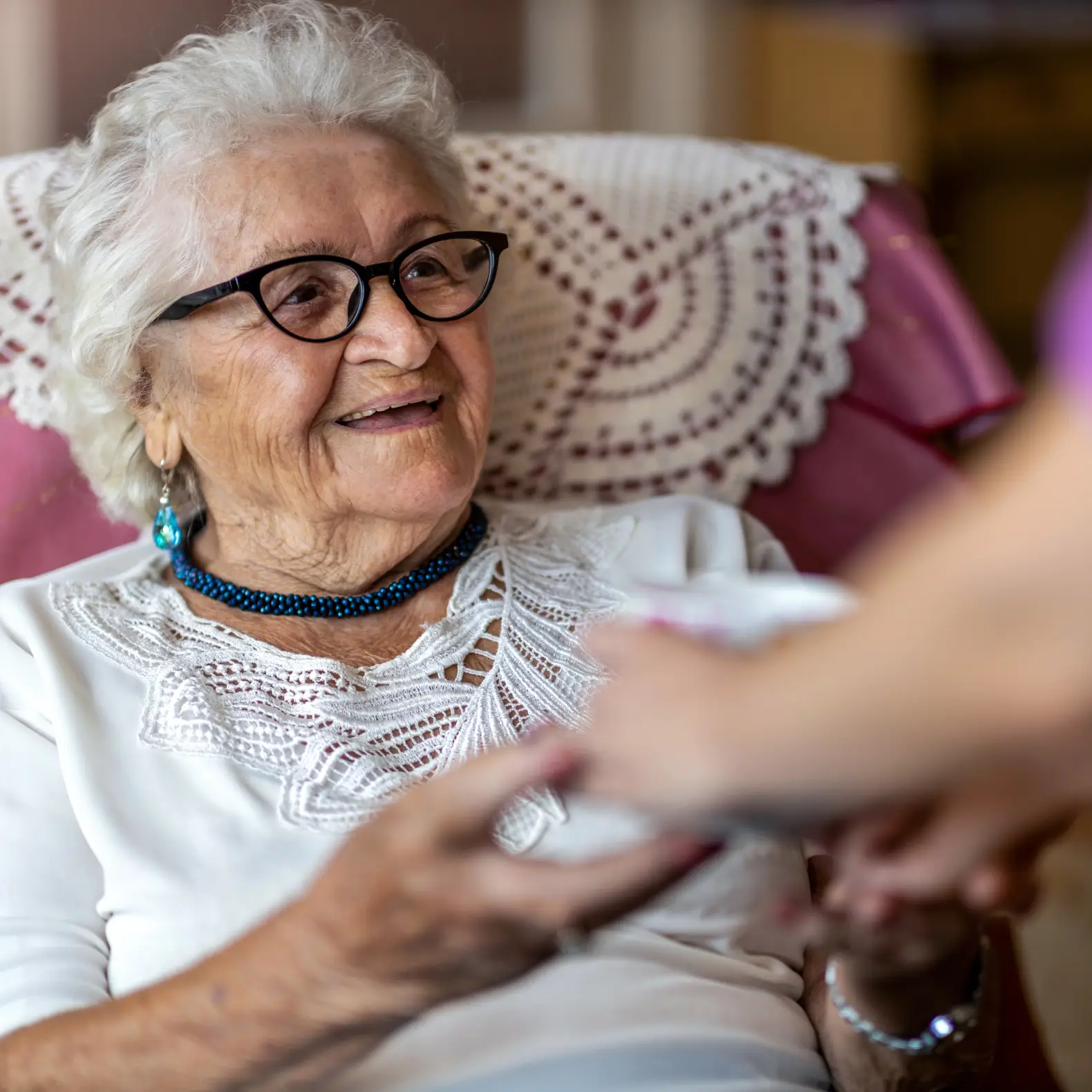 Care professional providing ongoing support to an older adult, representing Step 6 ongoing service coordination and advocacy for Medicaid Waiver Program