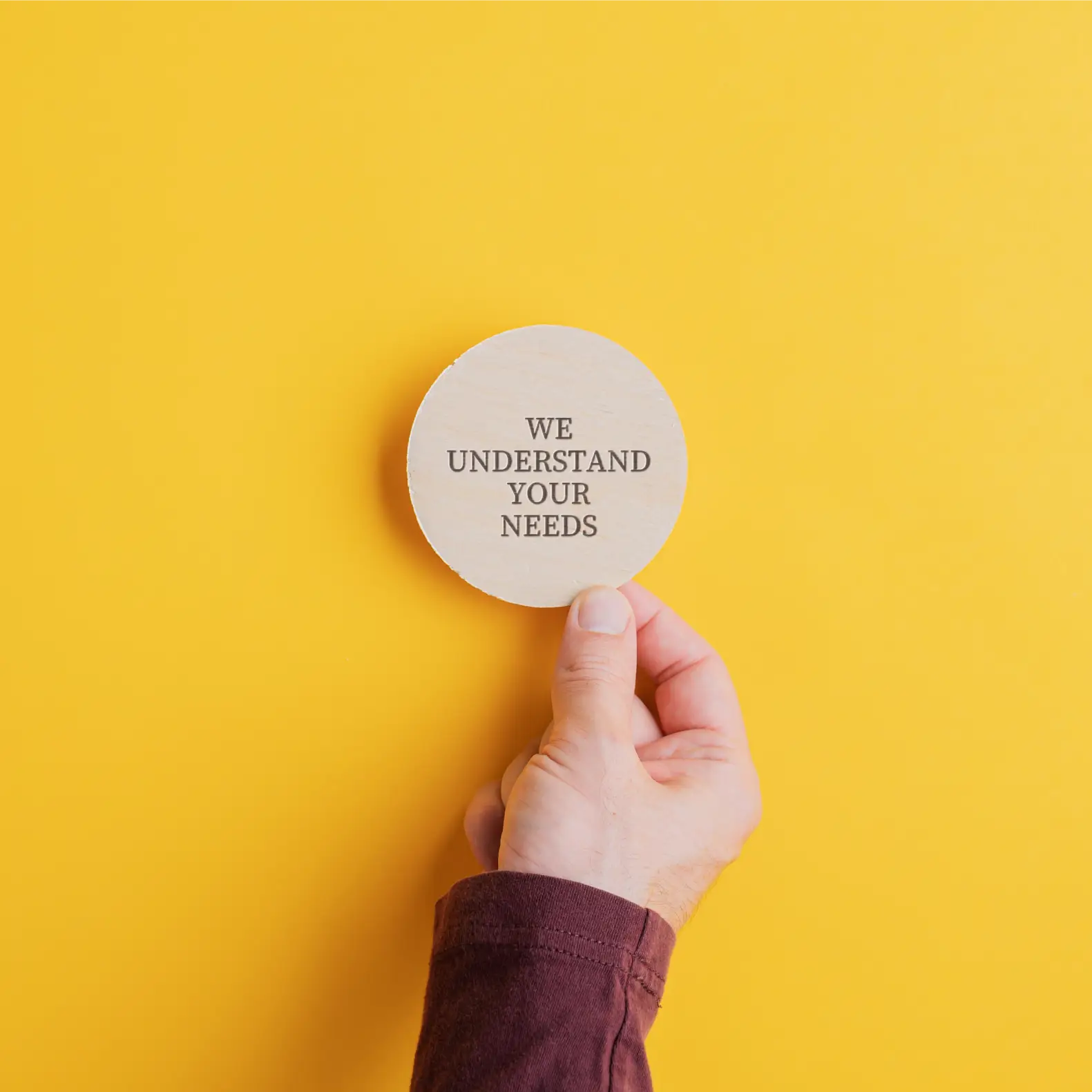 Step 1 Speak with a CoordinatorHand holding a sign reading “We understand your needs,” representing guidance with Medicaid Waiver Programs in Brooklyn, New York